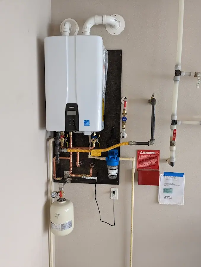Professional plumber installing copper piping in a Arvada home